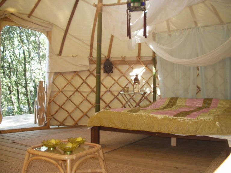 Yurt interior with view of bed and open door